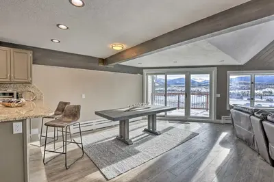 a kitchen with a ping pong table in a room with windows at Stunning Condo in Fraser with Mountain Views! in Fraser
