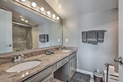 a bathroom with two sinks and a large mirror at Stunning Condo in Fraser with Mountain Views! in Fraser