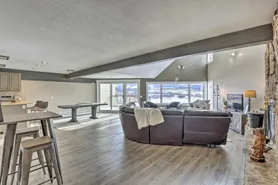 a living room with a couch and a table at Stunning Condo in Fraser with Mountain Views! in Fraser