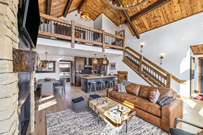 a living room with a couch and a table at Indoor/Outdoor Fireplace, Jacuzzi, Heated Bathroom Floors in Estes Park