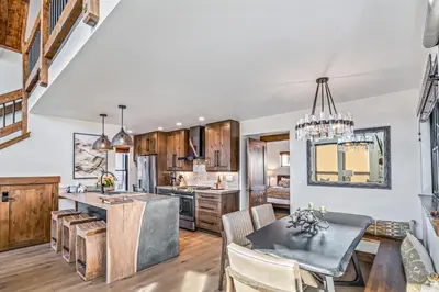 a kitchen and dining room with a table and chairs at Indoor/Outdoor Fireplace, Jacuzzi, Heated Bathroom Floors in Estes Park