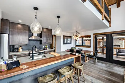 an open kitchen with wooden cabinets and a counter top at Indoor/Outdoor Fireplace, Jacuzzi, Heated Bathroom Floors in Estes Park