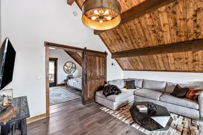 a living room with a couch and a table at Indoor/Outdoor Fireplace, Jacuzzi, Heated Bathroom Floors in Estes Park