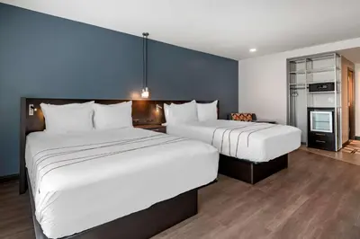 a hotel room with two beds and a kitchen at Vīb Hotel by Best Western Denver RiNo in Denver