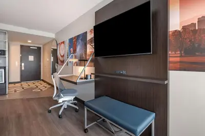 a room with a desk and a chair and a tv at Vīb Hotel by Best Western Denver RiNo in Denver