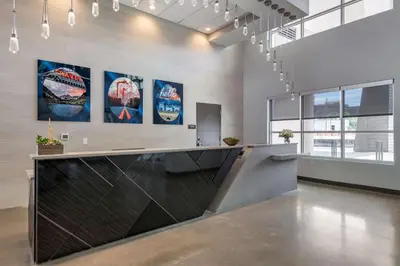 a lobby with a reception desk and posters on the wall at Vīb Hotel by Best Western Denver RiNo in Denver
