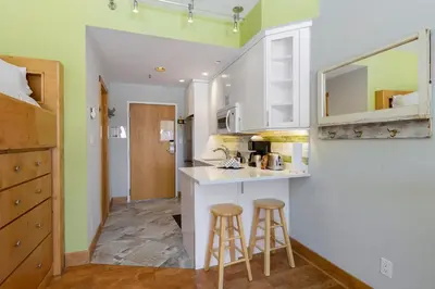a kitchen with two bar stools and a counter at 2754 Slopeside condo in Keystone