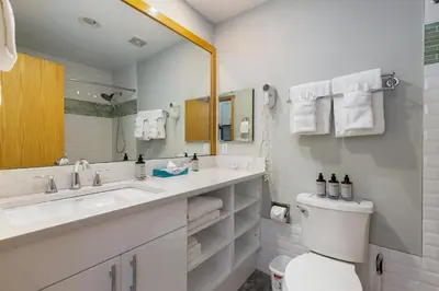 a bathroom with a toilet and a sink and a mirror at 2754 Slopeside condo in Keystone