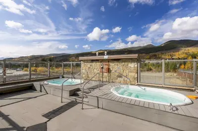a patio with two hot tubs on a deck at 2754 Slopeside condo in Keystone