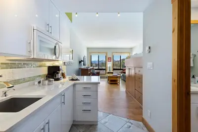 a kitchen with white cabinets and a counter top at 2754 Slopeside condo in Keystone