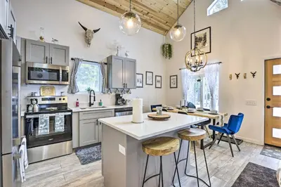 a kitchen with a table and chairs in a room at 1 Mi to St Marys Glacier Trail Modern Mtn Cabin! in Idaho Springs