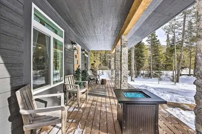 a screened porch with a hot tub on a house at 1 Mi to St Marys Glacier Trail Modern Mtn Cabin! in Idaho Springs