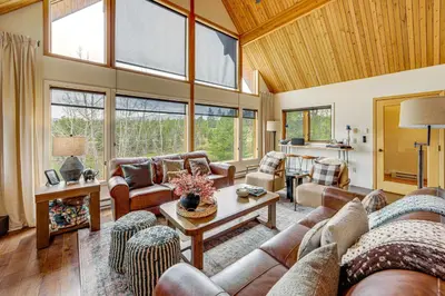 a large living room with a lot of furniture and windows at Dreamy Escape Btwn Winter Park and Lake Granby! in Tabernash