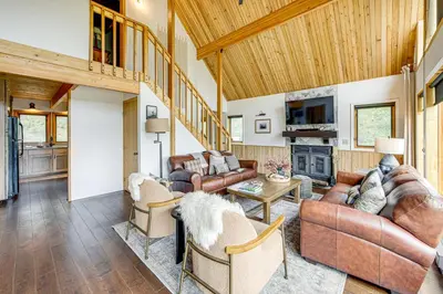 a living room with leather furniture and a wooden ceiling at Dreamy Escape Btwn Winter Park and Lake Granby! in Tabernash