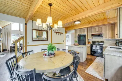 a kitchen and dining room with a wooden ceiling at Dreamy Escape Btwn Winter Park and Lake Granby! in Tabernash