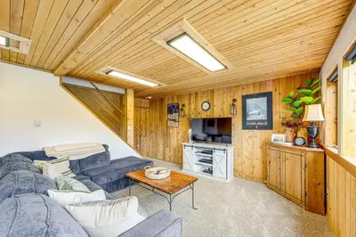 a living room with a couch and a table at Dreamy Escape Btwn Winter Park and Lake Granby! in Tabernash