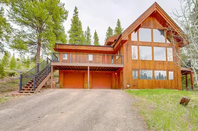 a large wooden house with a garage at Dreamy Escape Btwn Winter Park and Lake Granby! in Tabernash