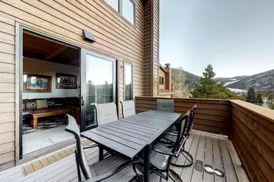 a wooden deck with a wooden table and chairs at Tennis Townhome 1312 in Keystone