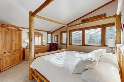a bedroom with a large bed with a wooden frame at Tennis Townhome 1312 in Keystone
