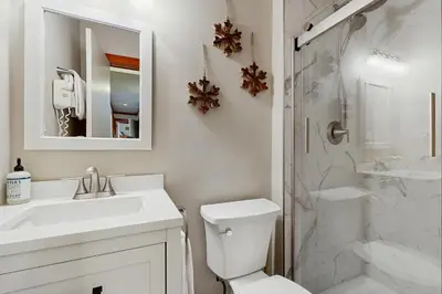 a bathroom with a toilet and a sink and a shower at Tennis Townhome 1312 in Keystone