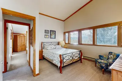 a bedroom with a bed and two windows at Tennis Townhome 1312 in Keystone