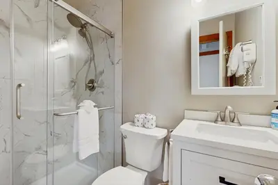 a bathroom with a toilet and a sink and a shower at Tennis Townhome 1312 in Keystone
