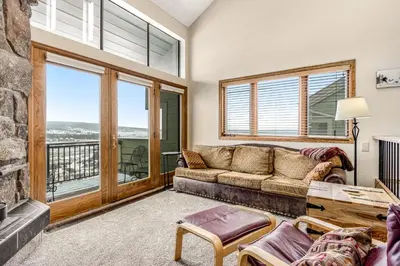 a living room with a couch and a fireplace at Railbender 8 in Fraser
