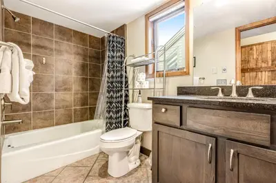 a bathroom with a toilet and a tub and a sink at Railbender 8 in Fraser