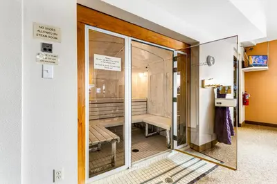a sliding glass door with a bench in a room at Railbender 8 in Fraser