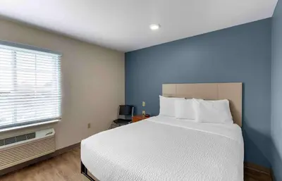 a bedroom with a white bed and a window at Extended Stay America Select Suites - Firestone in Firestone