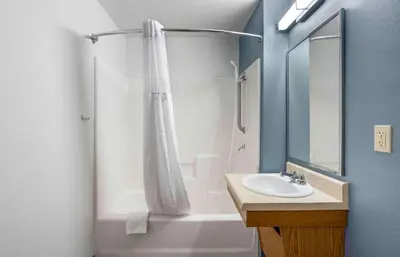 a bathroom with a shower curtain and a sink at Extended Stay America Select Suites - Firestone in Firestone