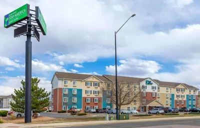 a street sign in front of a building at Extended Stay America Select Suites - Firestone in Firestone