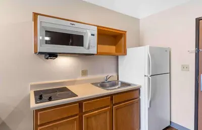 a small kitchen with a sink and a microwave at Extended Stay America Select Suites - Loveland in Loveland