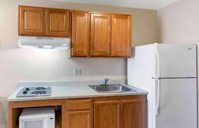 a kitchen with a sink and a white refrigerator at Extended Stay America Select Suites - Loveland in Loveland