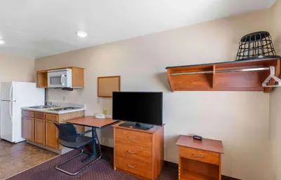 a room with a kitchen with a desk and a refrigerator at Extended Stay America Select Suites - Loveland in Loveland