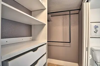 a walk in closet with a toilet and a glass door at Contemporary Longmont Hideaway in Old Town! in Longmont