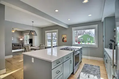 a kitchen with a stove top island in a room at Contemporary Longmont Hideaway in Old Town! in Longmont
