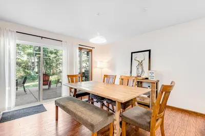 a dining room with a wooden table and chairs at Meadow Lodge - Dog Friendly! in Frisco
