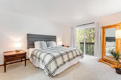 a bedroom with a bed and a large window at Meadow Lodge - Dog Friendly! in Frisco