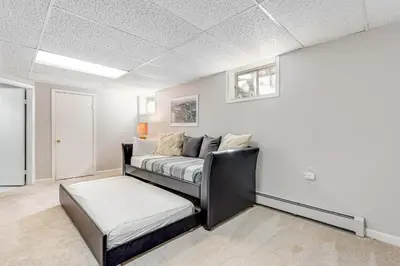 a living room with a bed and a ottoman at Meadow Lodge - Dog Friendly! in Frisco
