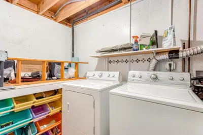 a laundry room with two washing machines and shelves at Meadow Lodge - Dog Friendly! in Frisco