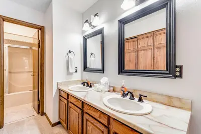 a bathroom with two sinks and a mirror at Meadow Lodge - Dog Friendly! in Frisco