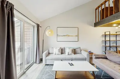 a living room with a couch and a table at Fraser Family Getaway in Fraser