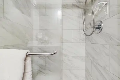 a bathroom with a shower with a glass door at Fraser Family Getaway in Fraser