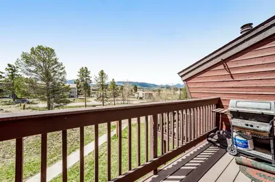 a wooden deck with a grill on a house at Fraser Family Getaway in Fraser
