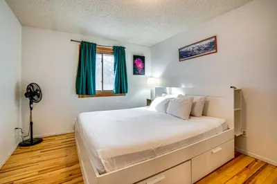 a bedroom with a large white bed with a window at Walk to Main St Recently Renovated Frisco Condo in Frisco