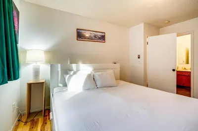 a white bed with white pillows in a bedroom at Walk to Main St Recently Renovated Frisco Condo in Frisco