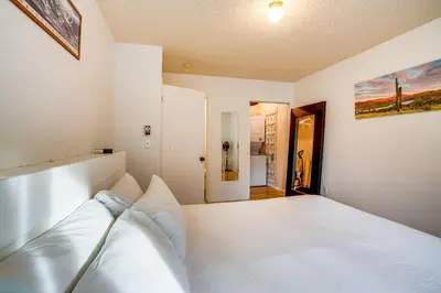 a white bedroom with a large white bed in it at Walk to Main St Recently Renovated Frisco Condo in Frisco