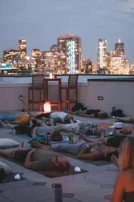 a group of people laying on the roof of a building at A Denver Skyline State of Mind - Zuni Lofts in Denver