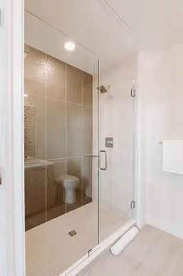 a glass shower in a bathroom with a toilet at Top Floor - Amazing Windows - Zuni Lofts in Denver